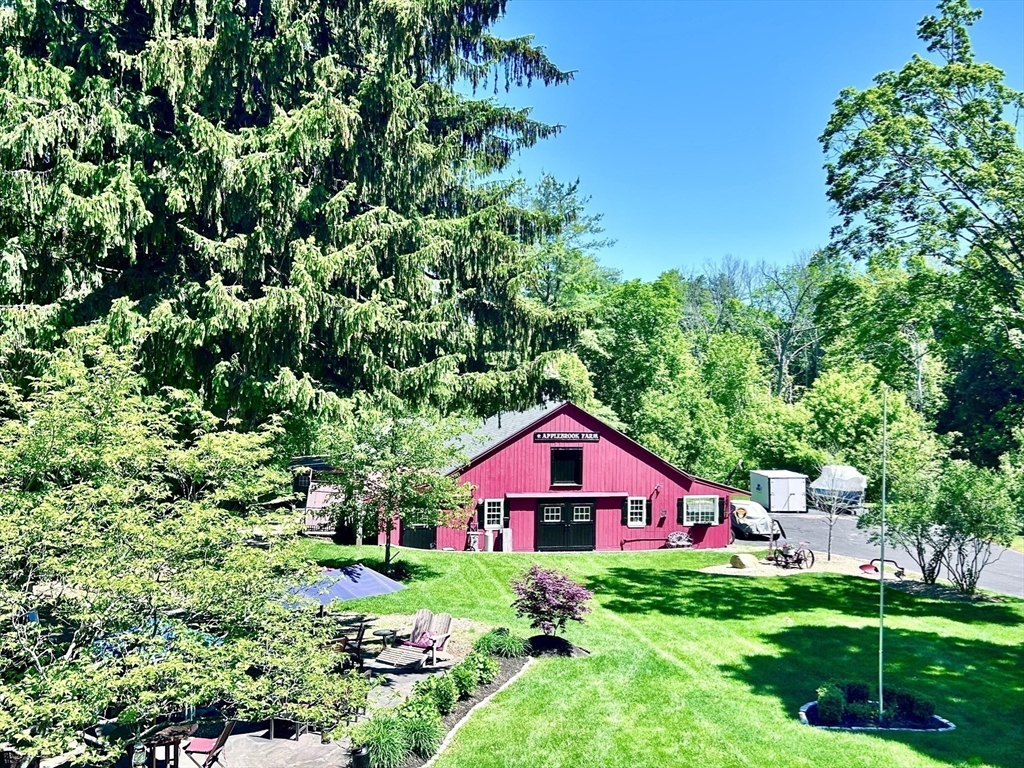 10 Garrison Street Groveland, MA 01834 - Photo 38 of 42 a view of a yard in front of a house with plants and large trees