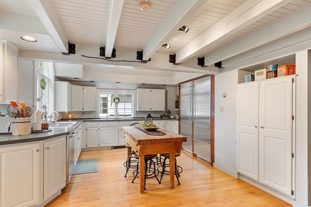 10 Garrison Street Groveland, MA 01834 - Photo 6 of 42 a kitchen with stainless steel appliances kitchen island granite countertop a table chairs sink and cabinets