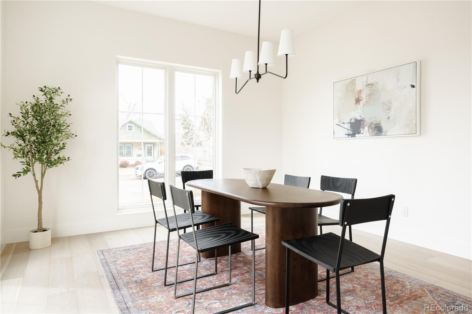 3076 Fenton Street Wheat Ridge, CO 80214 - Photo 17 of 37 a view of a dining room with furniture window and wooden floor
