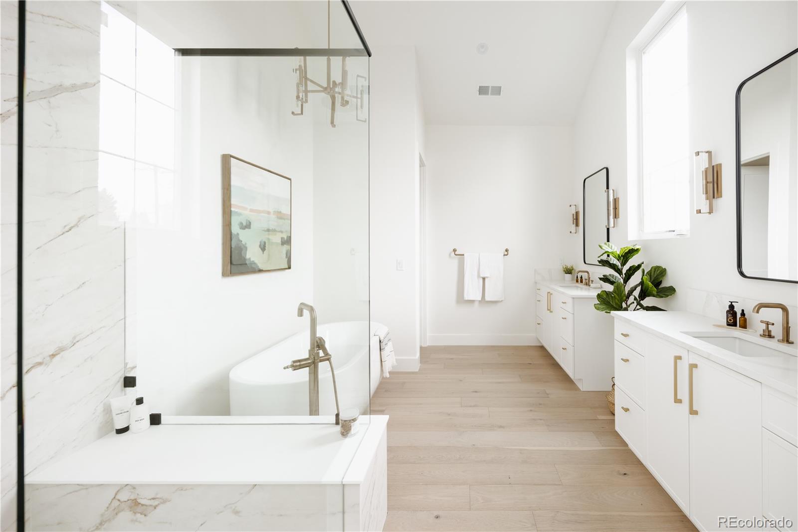 3076 Fenton Street Wheat Ridge, CO 80214 - Photo 21 of 37 a bathroom with a bathtub sink and mirror