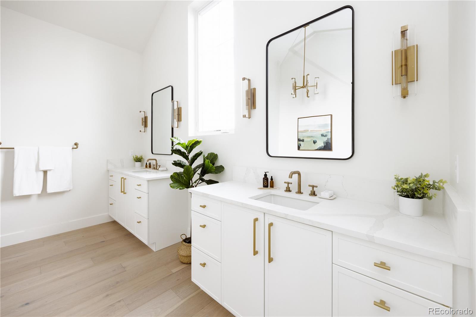 3076 Fenton Street Wheat Ridge, CO 80214 - Photo 22 of 37 a bathroom with a sink a mirror and a potted plant