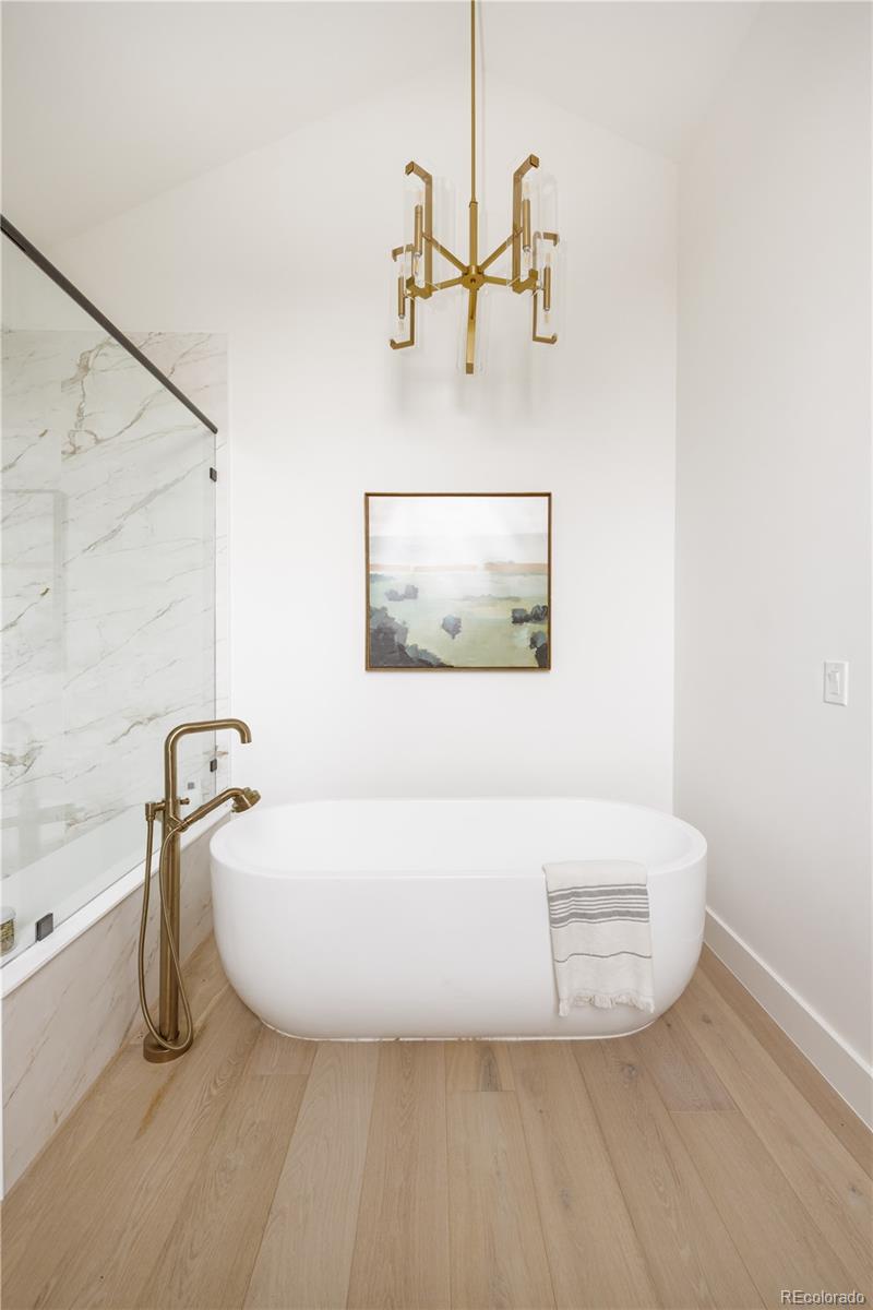 3076 Fenton Street Wheat Ridge, CO 80214 - Photo 23 of 37 a bathroom with a bathtub and shower