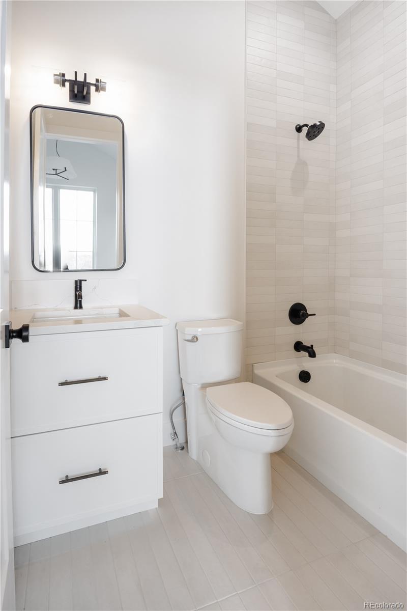 3076 Fenton Street Wheat Ridge, CO 80214 - Photo 28 of 37 a bathroom with a toilet sink and mirror