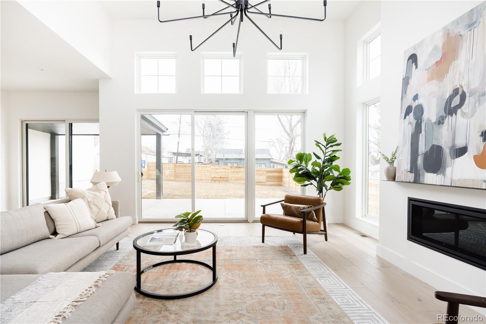 3076 Fenton Street Wheat Ridge, CO 80214 - Photo 7 of 37 a living room with furniture potted plant and a large window