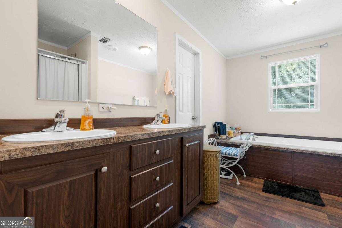 3516 Bennetts Landing Road Millen, GA 30442 - Photo 17 of 34 a spacious bathroom with a granite countertop sink and a mirror