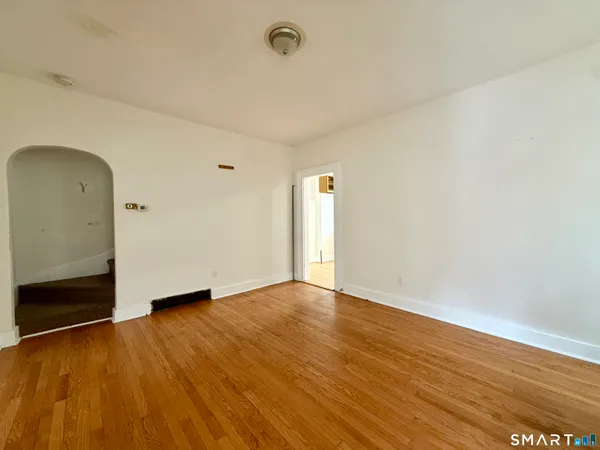 a view of an empty room and wooden floor