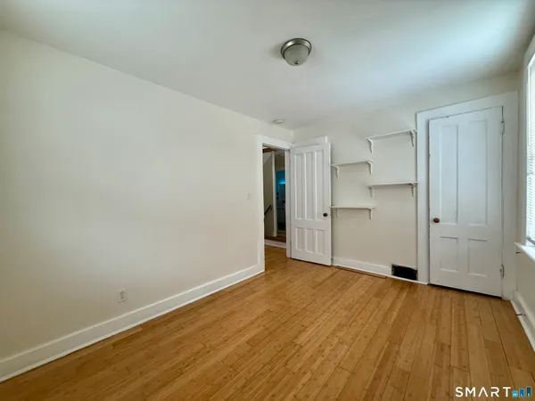 a view of an empty room and wooden floor