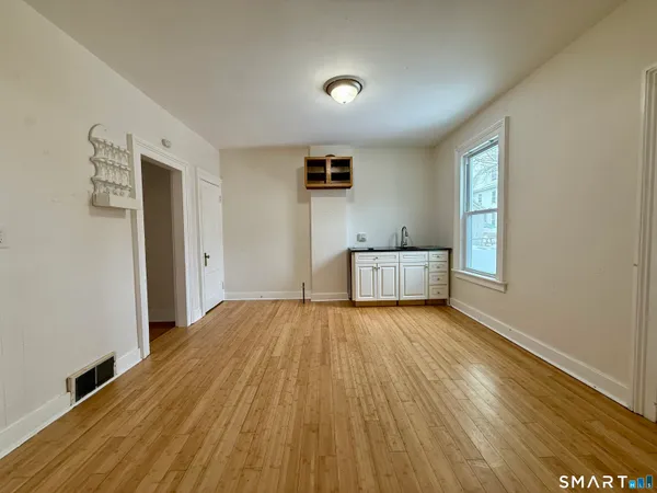 a kitchen with granite countertop a sink and cabinets