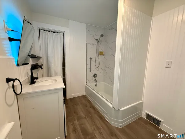 a bathroom with a shower and toilet