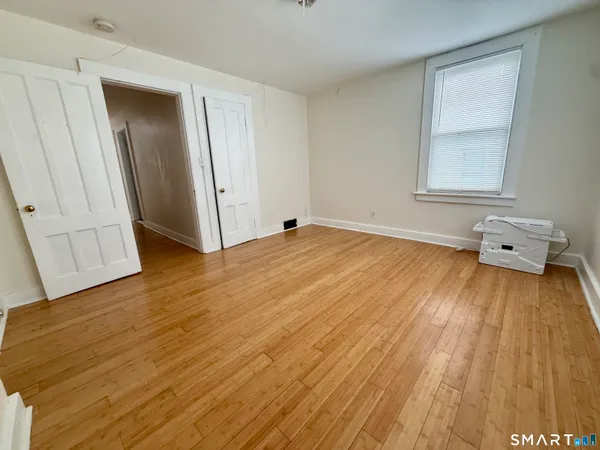 a view of an empty room and wooden floor