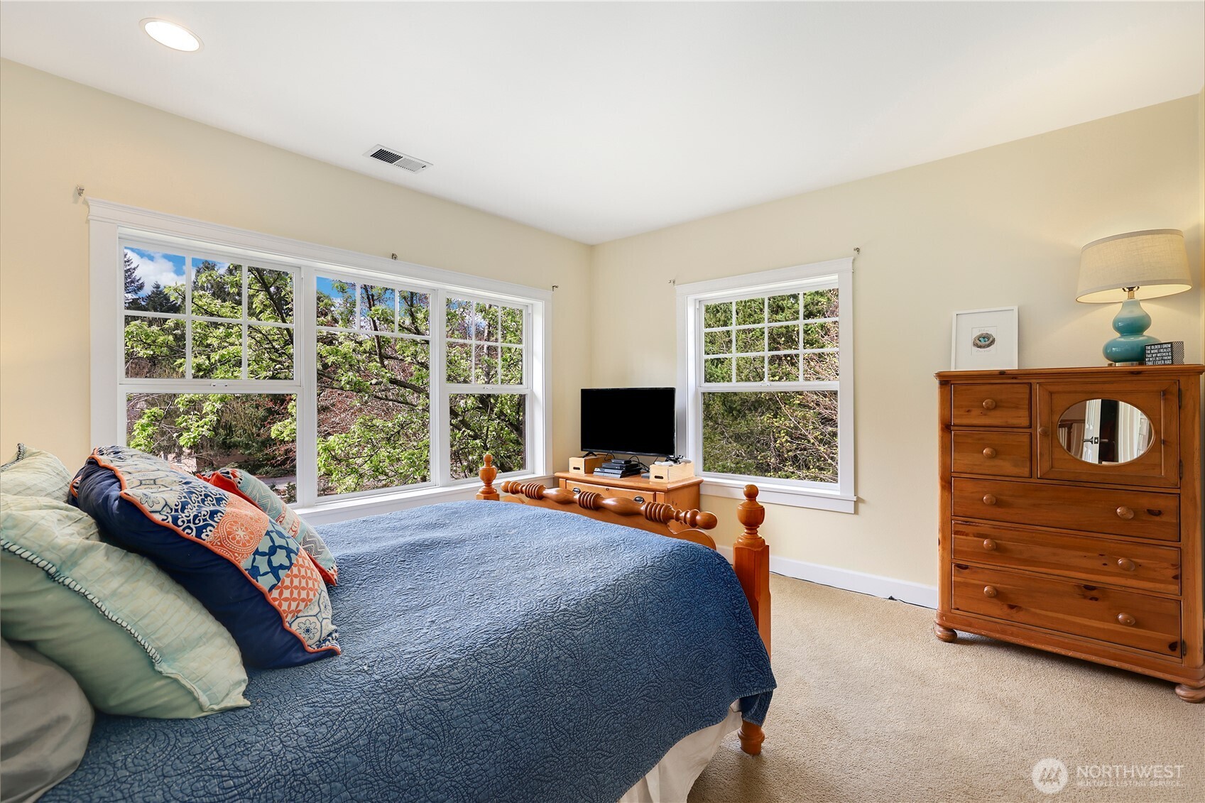 7007 Muirkirk Lane Southwest Port Orchard, WA 98367 - Photo 18 of 40 a bed sitting in a bedroom next to a window with dresser