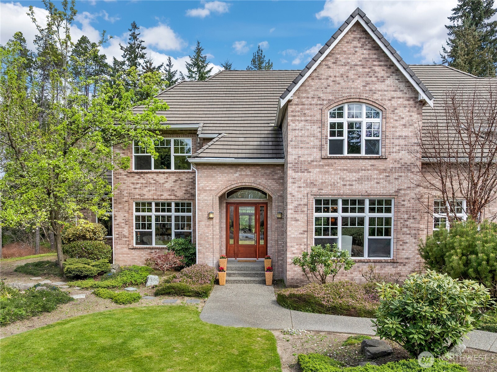 7007 Muirkirk Lane Southwest Port Orchard, WA 98367 - Photo 2 of 40 a front view of a house with garden