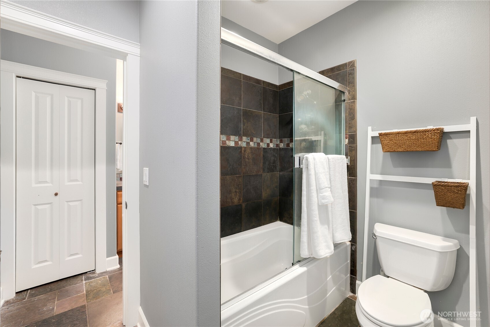 7007 Muirkirk Lane Southwest Port Orchard, WA 98367 - Photo 22 of 40 a white toilet sitting next to a bathroom sink