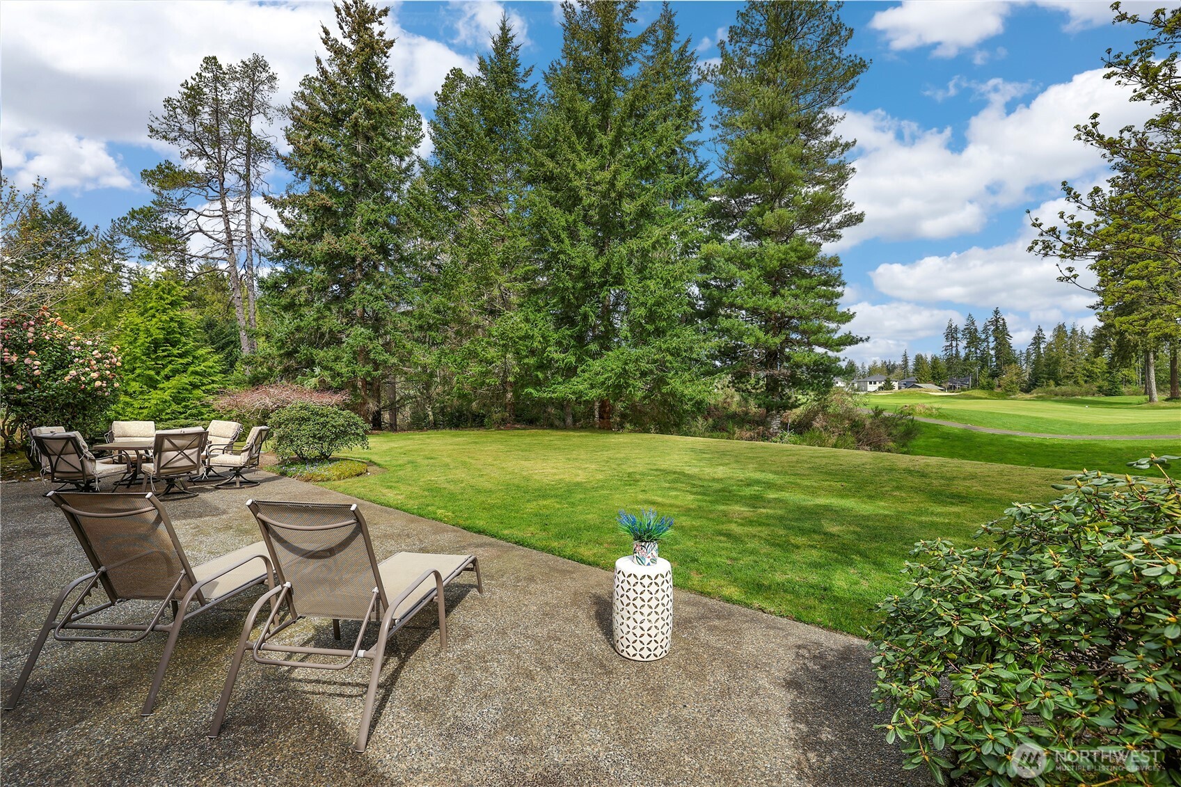 7007 Muirkirk Lane Southwest Port Orchard, WA 98367 - Photo 29 of 40 a view of a house with backyard sitting area and garden
