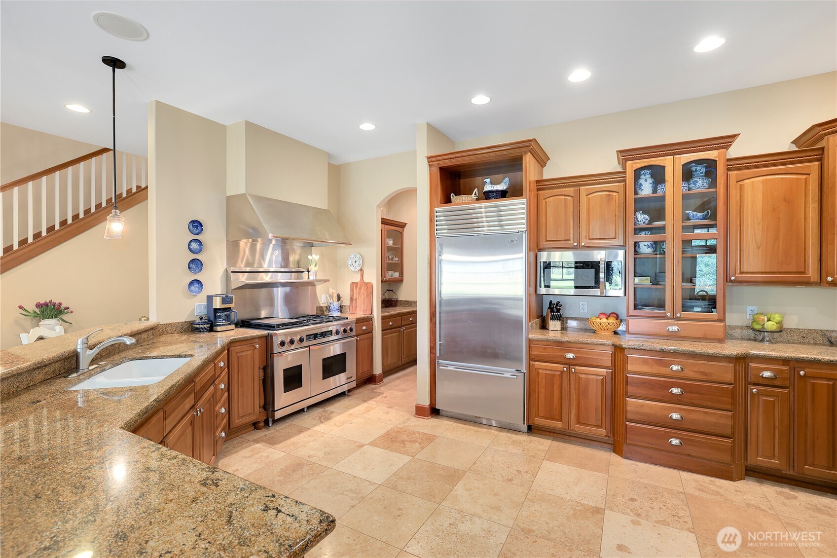 7007 Muirkirk Lane Southwest Port Orchard, WA 98367 - Photo 6 of 40 a kitchen with stainless steel appliances granite countertop a stove a sink and a refrigerator