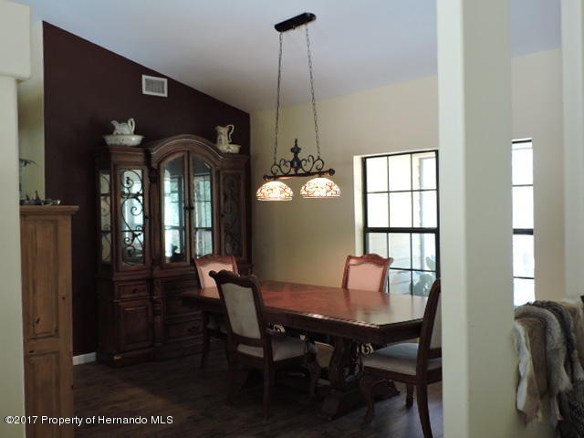 1156 Arlanie Road Brooksville, FL 34604 - Photo 12 of 27 a dining room with furniture and window