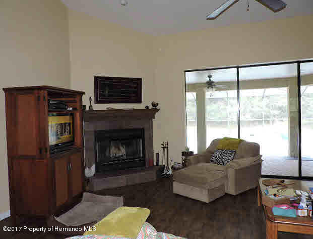 1156 Arlanie Road Brooksville, FL 34604 - Photo 13 of 27 a living room with furniture and a fireplace