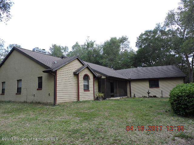 1156 Arlanie Road Brooksville, FL 34604 - Photo 2 of 27 a view of a house with a back yard