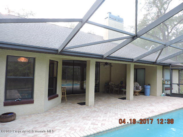 1156 Arlanie Road Brooksville, FL 34604 - Photo 5 of 27 a view of a patio with table and chairs