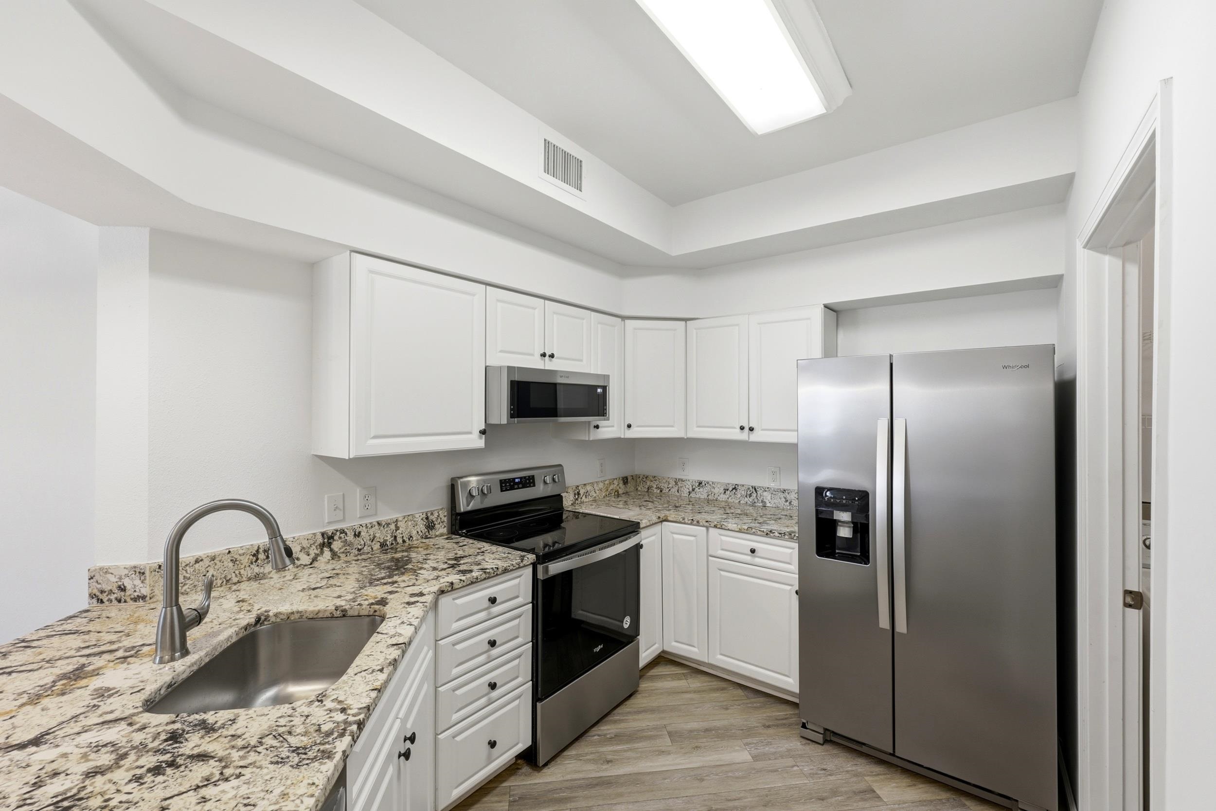 2500 Vista Cove Road St. Augustine, FL 32084 - Photo 13 of 53 a kitchen with stainless steel appliances granite countertop a sink a stove a refrigerator a stove with cabinets