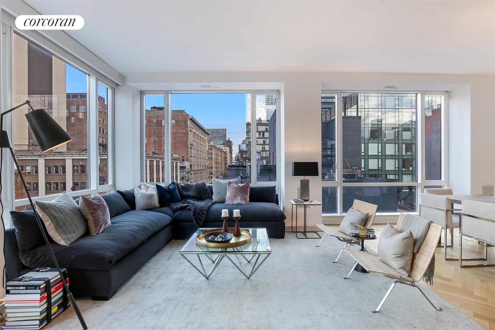 a living room with furniture and floor to ceiling windows