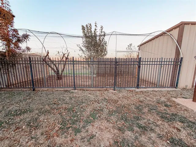 a view of a backyard with sitting area