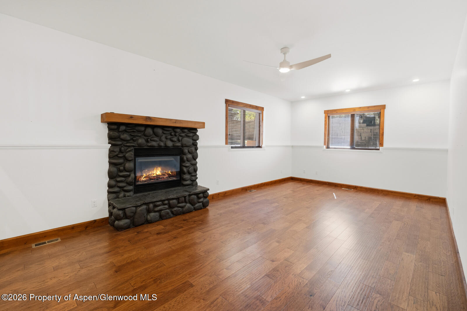 316 Faas Ranch Road New Castle, CO 81647 - Photo 18 of 50 a view of an empty room with wooden floor fireplace and a window