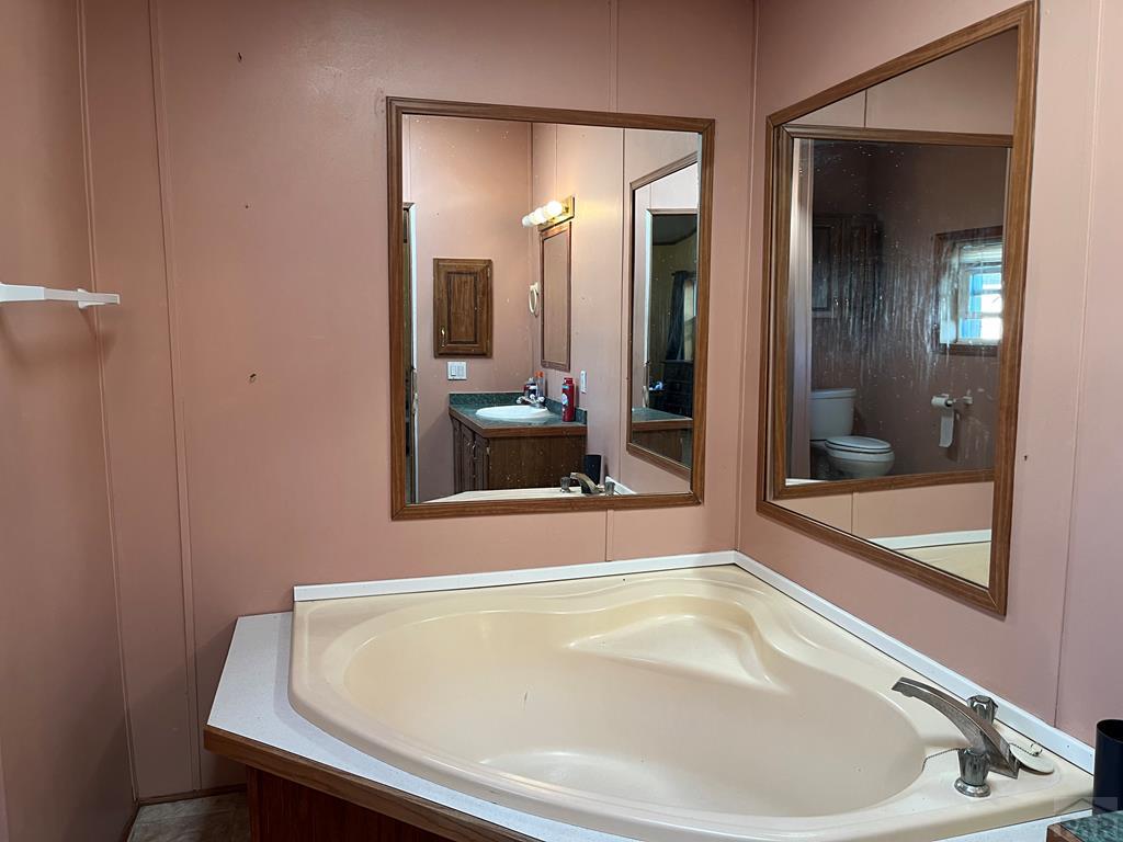 805 7th Street Fowler, CO 81039 - Photo 11 of 20 a bathroom with a tub and shower