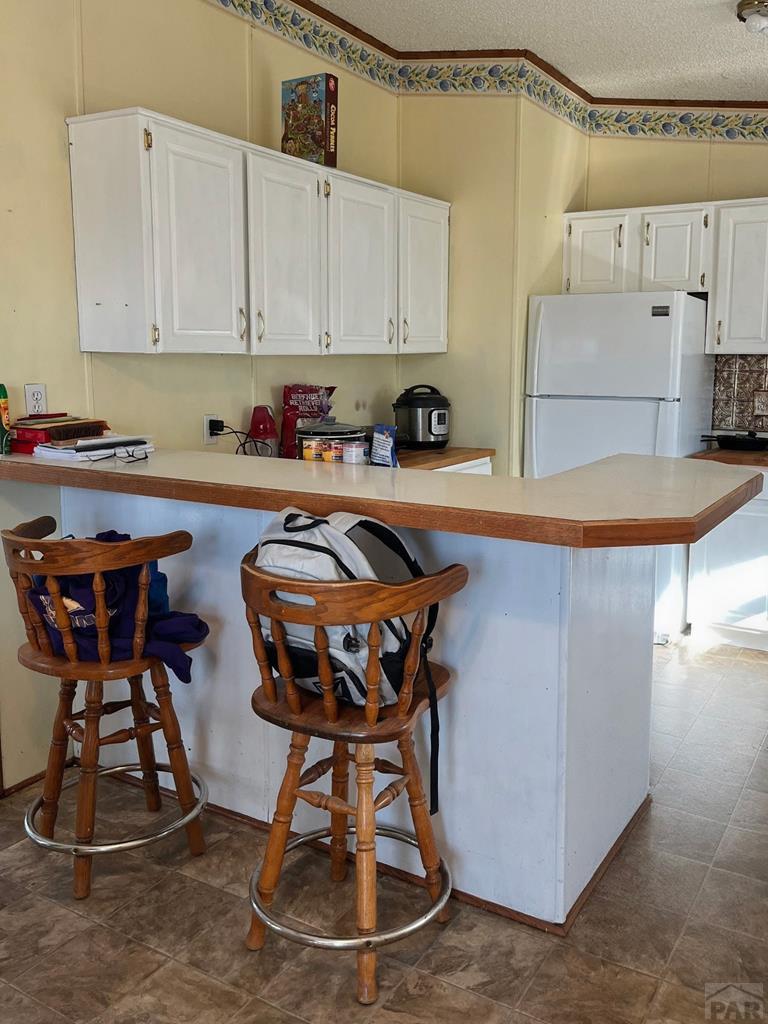 805 7th Street Fowler, CO 81039 - Photo 5 of 20 a kitchen with a sink a stove and white cabinets
