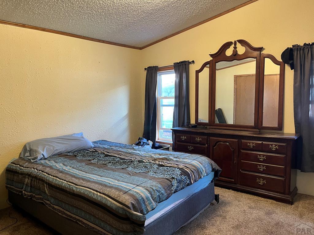 805 7th Street Fowler, CO 81039 - Photo 9 of 20 a bedroom with a bed and a dresser