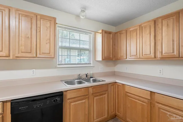 a kitchen with stainless steel appliances white cabinets and a sink