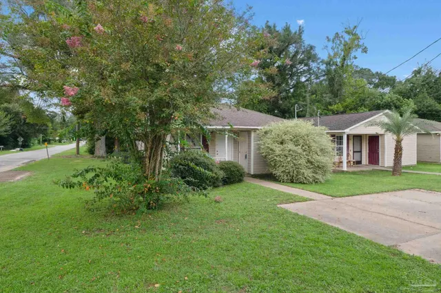 a front view of a house with garden