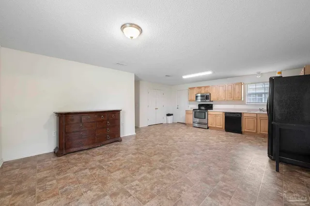 a view of a kitchen with a sink and a refrigerator