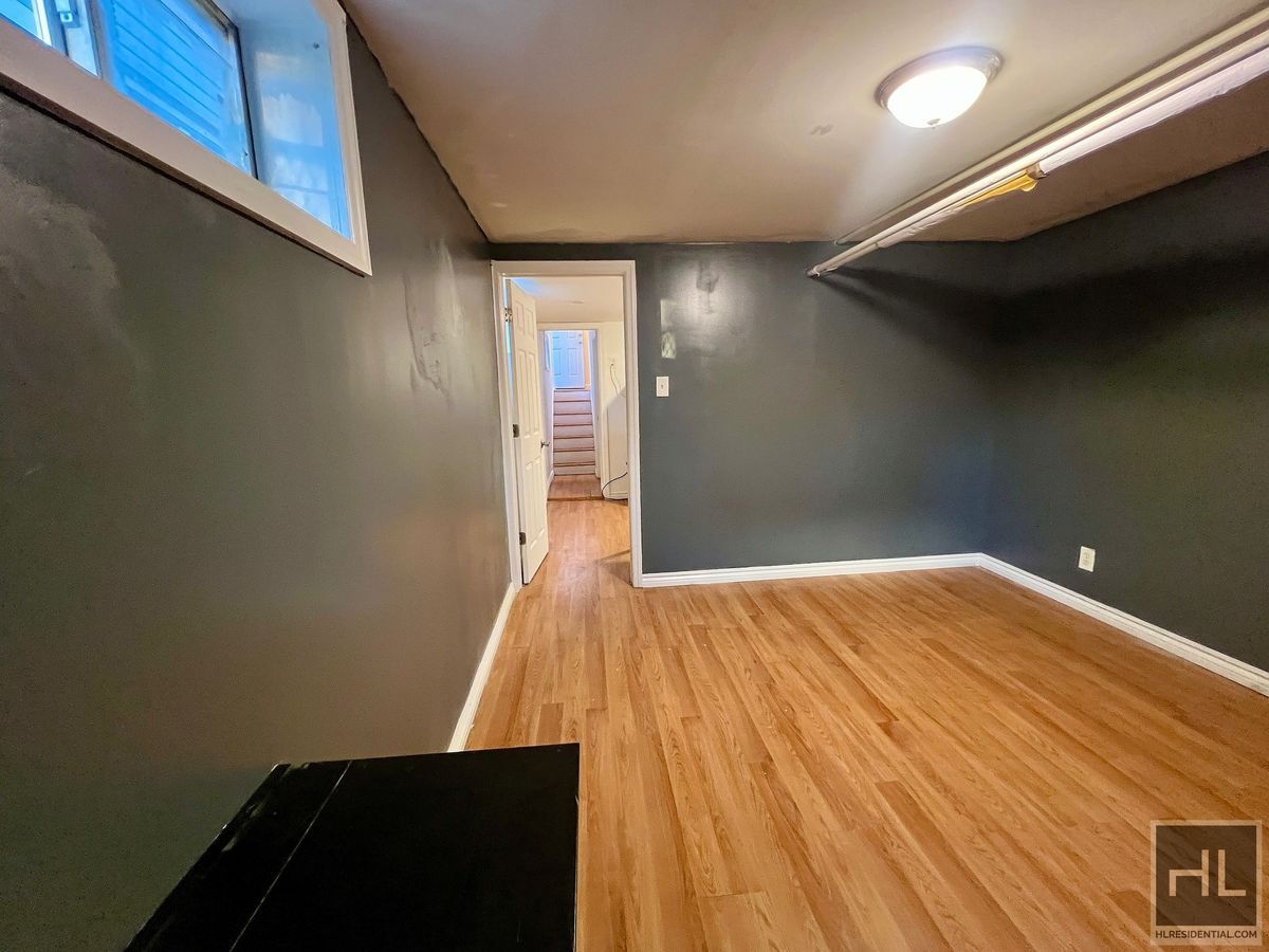 1339 East 91st Street, Unit 1B Brooklyn, NY 11236 - Photo 12 of 12 a view of an empty room with wooden floor