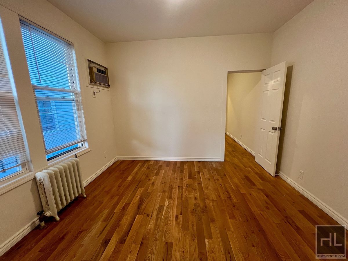 1339 East 91st Street, Unit 1B Brooklyn, NY 11236 - Photo 4 of 12 a view of a room with wooden floor and staircase
