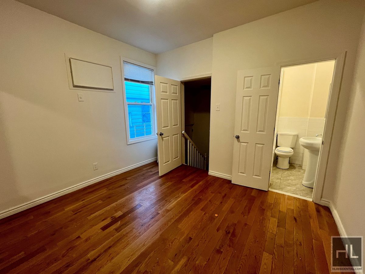 1339 East 91st Street, Unit 1B Brooklyn, NY 11236 - Photo 5 of 12 a view of empty room with wooden floor and window