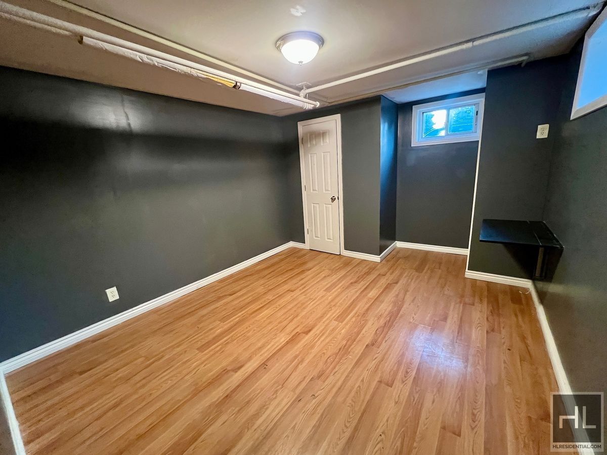 1339 East 91st Street, Unit 1B Brooklyn, NY 11236 - Photo 10 of 12 a view of empty room with wooden floor