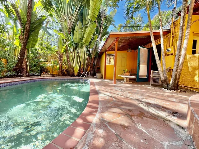 a view of a backyard with swimming pool