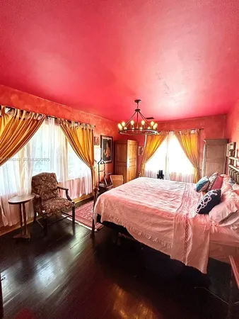 a bedroom with a bed and a potted plant