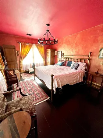 a bed sitting in a bedroom next to a window