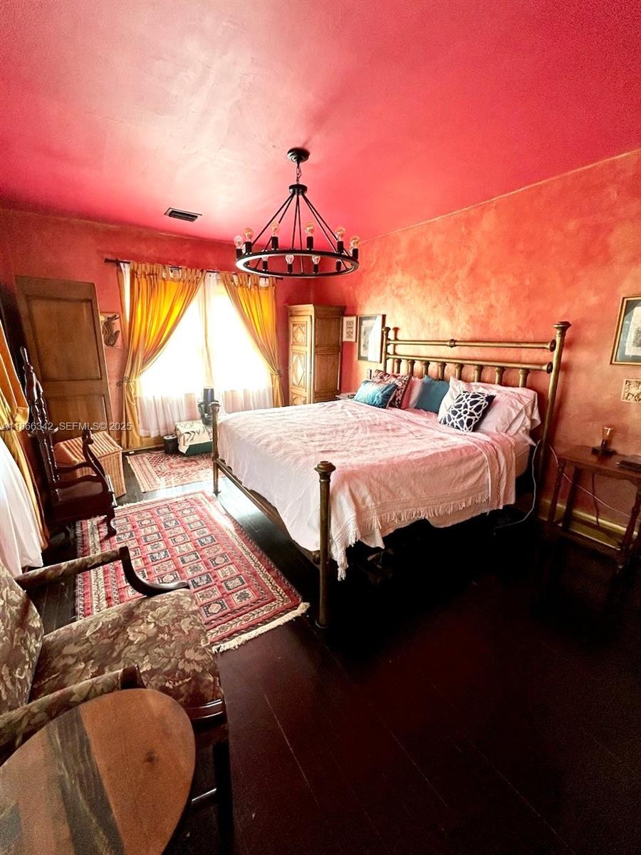 168 Northeast 44th Street Miami, FL 33137 - Photo 20 of 46 a bed sitting in a bedroom next to a window