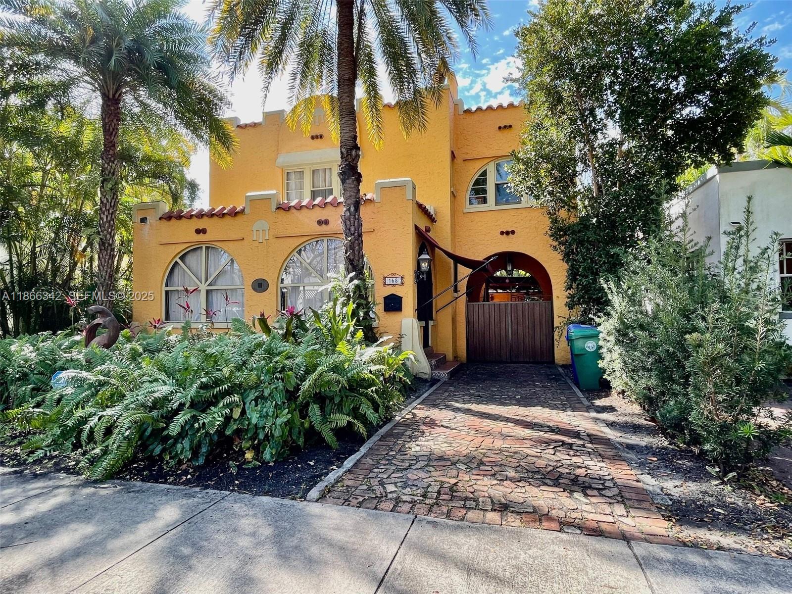 168 Northeast 44th Street Miami, FL 33137 - Photo 2 of 46 a front view of a house with a garden