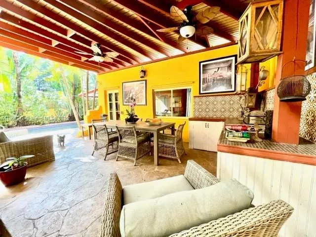 a living room with furniture a rug and a large window