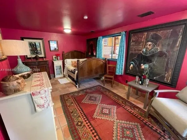 a living room with furniture a rug and a large window