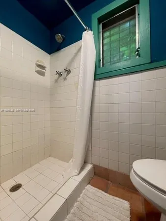 a bathroom with a toilet and shower