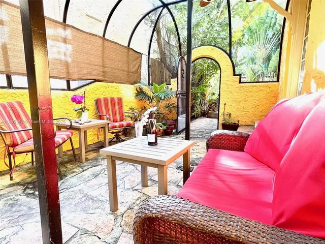 a living room with furniture and a floor to ceiling window