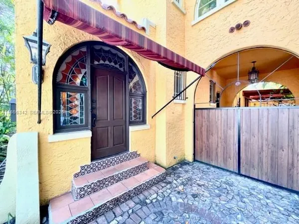 a front view of a house with a garden