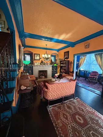 a living room with furniture a fireplace and a table