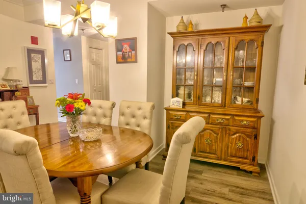 a view of a dining room with furniture and chandelier