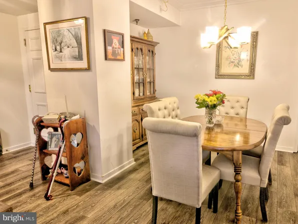 a view of a workspace with furniture and wooden floor